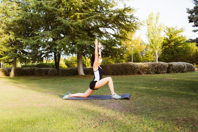 Full length of woman exercising in park