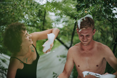 Man and smiling while sitting on tree