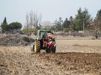 Tractor on field against clear sky