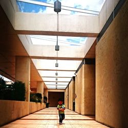 Rear view of people walking in corridor