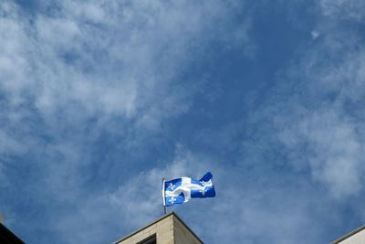 Low angle view of building against cloudy sky