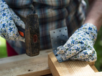 Midsection of woman working on wood