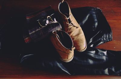 High angle view of black shoes on wooden table