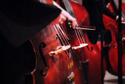 Cropped image of musician playing cellos