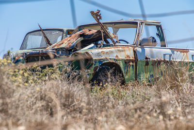 Abandoned cars on field