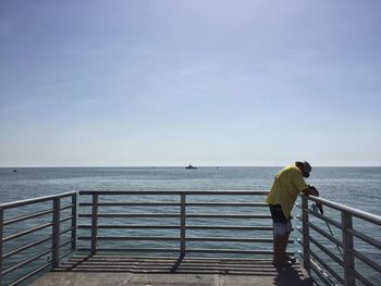 Silhouette of man standing on pier