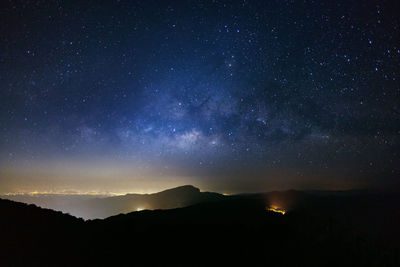 Scenic view of silhouette mountain against sky at night