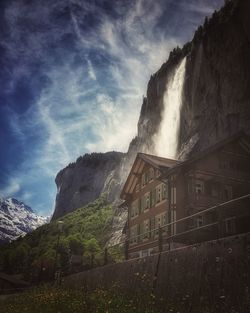 Low angle view of building and mountains against sky