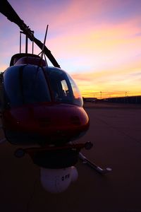 Close-up of airplane against sky during sunset