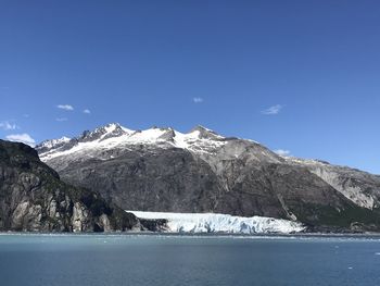 Scenic view of snowcapped mountain against blue sky