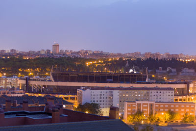 High angle view of illuminated buildings against sky at night