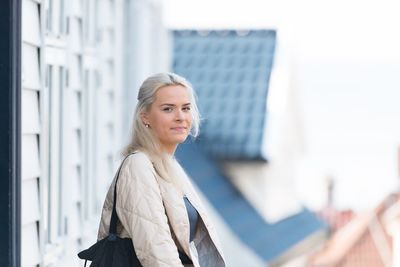 Portrait of young woman standing outdoors