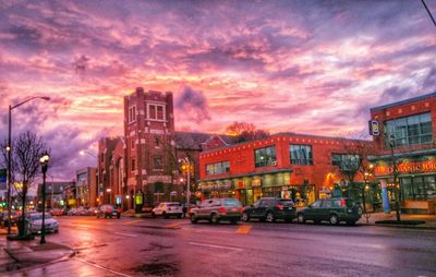 View of city street against cloudy sky