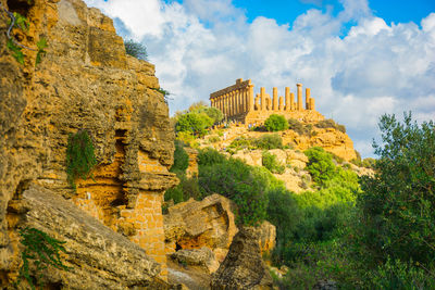 Ruins of temple against cloudy sky