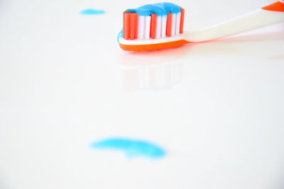 High angle view of colored pencils over white background