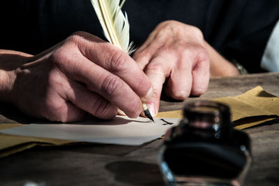 Close-up of hand writing a letter