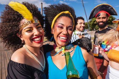 Portrait of smiling friends with friend