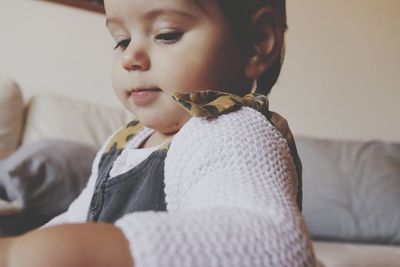 Portrait of cute girl sitting at home