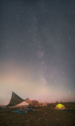 Low angle view of landscape against sky at night