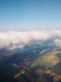 Aerial view of agricultural field against blue sky