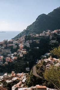 High angle view of townscape by sea against sky