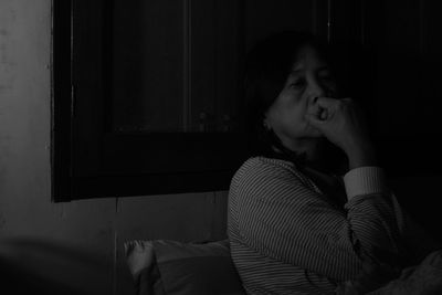 Close-up senior woman at home in dark