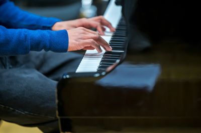 Cropped image of man playing piano