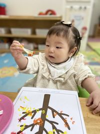 Portrait of cute girl drawing in library