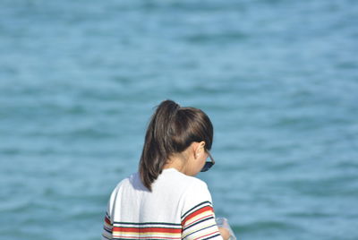 Rear view of woman against sea