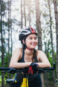 Portrait of smiling young woman riding bicycle