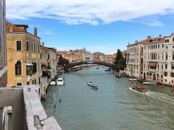 Boats in city against sky