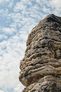 Low angle view of rock formation against sky