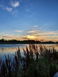 Scenic view of lake against sky during sunset