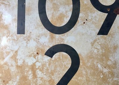 High angle view of rusty sign on wall