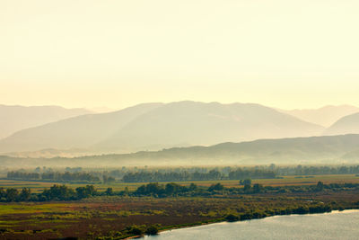 Scenic view of mountains against sky during foggy weather