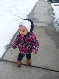 High angle view of girl standing in snow