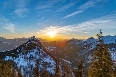 Scenic view of snowcapped mountains against sky during sunset