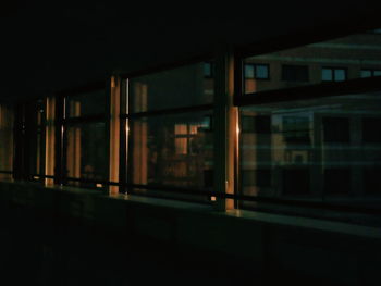 Illuminated building seen through train window at night