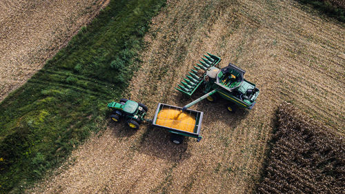 Combine harvesting corn and loading into an auger wagon in kentucky 