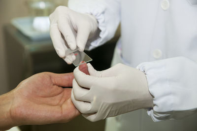 Cropped image of doctor examining patient in hospital