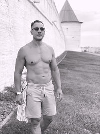 Portrait of shirtless man standing outdoors