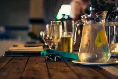 Close-up of wine glasses, water in a jar on the wedding table