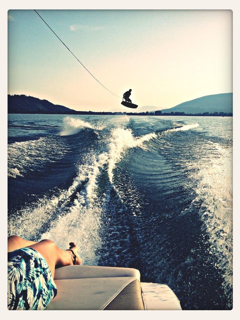 water, sea, transfer print, clear sky, lifestyles, auto post production filter, leisure activity, horizon over water, nautical vessel, scenics, men, beauty in nature, nature, full length, transportation, mountain, vacations, tranquility