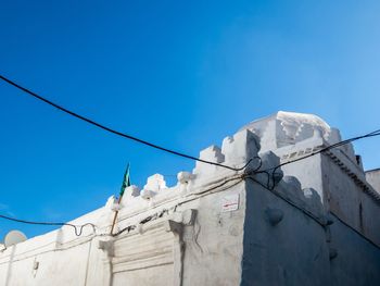 Low angle view of built structure against clear blue sky