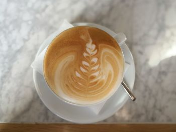 Directly above shot of cappuccino on marble floor