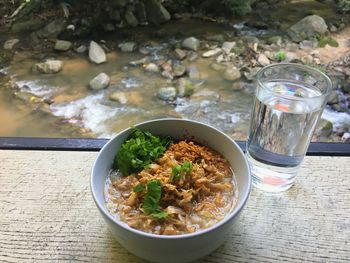 Food in bowl by stream on table