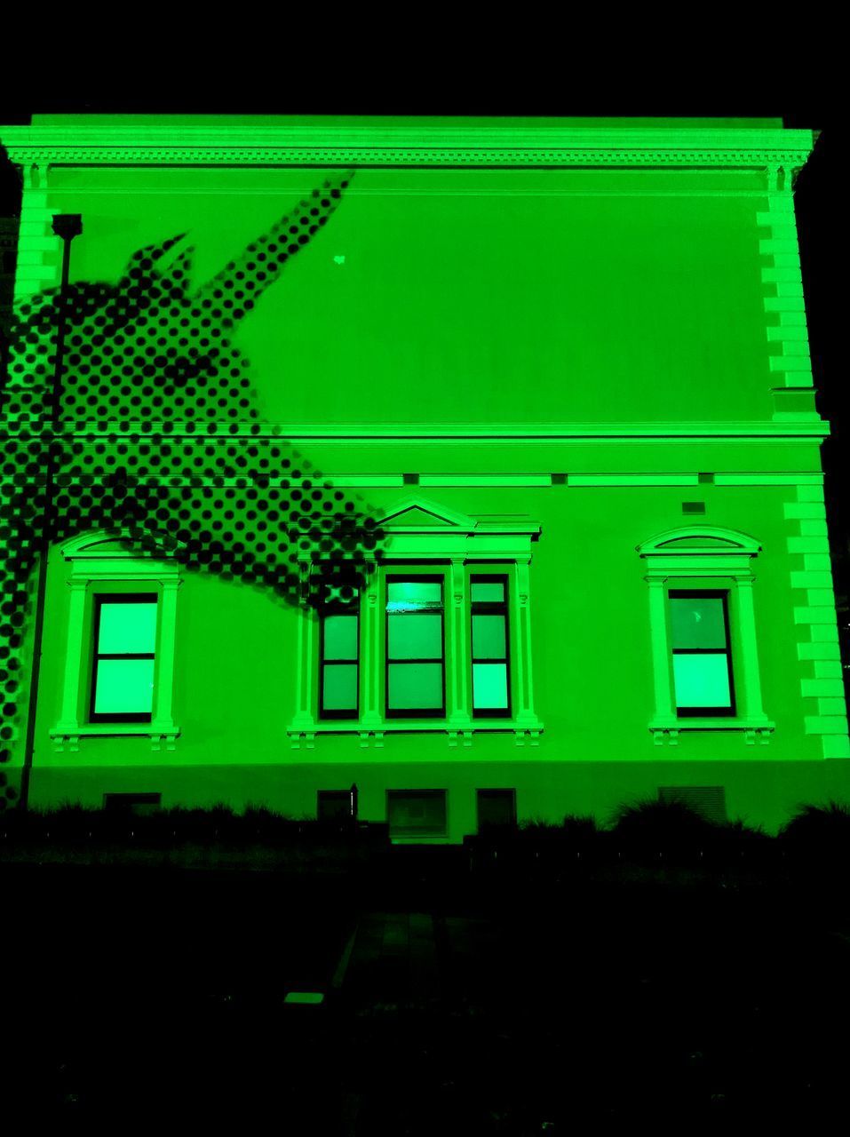 LOW ANGLE VIEW OF ILLUMINATED HOUSE WINDOW