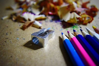 Multi colored pencils and sharpener on table
