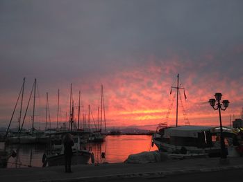 Silhouette sailboats moored on sea against sky during sunset
