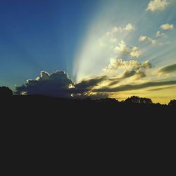 Silhouette of trees against sky at sunset